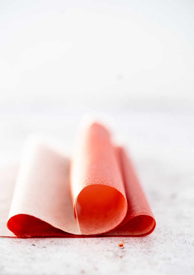 Close up shot of a single strawberry fruit roll up. 